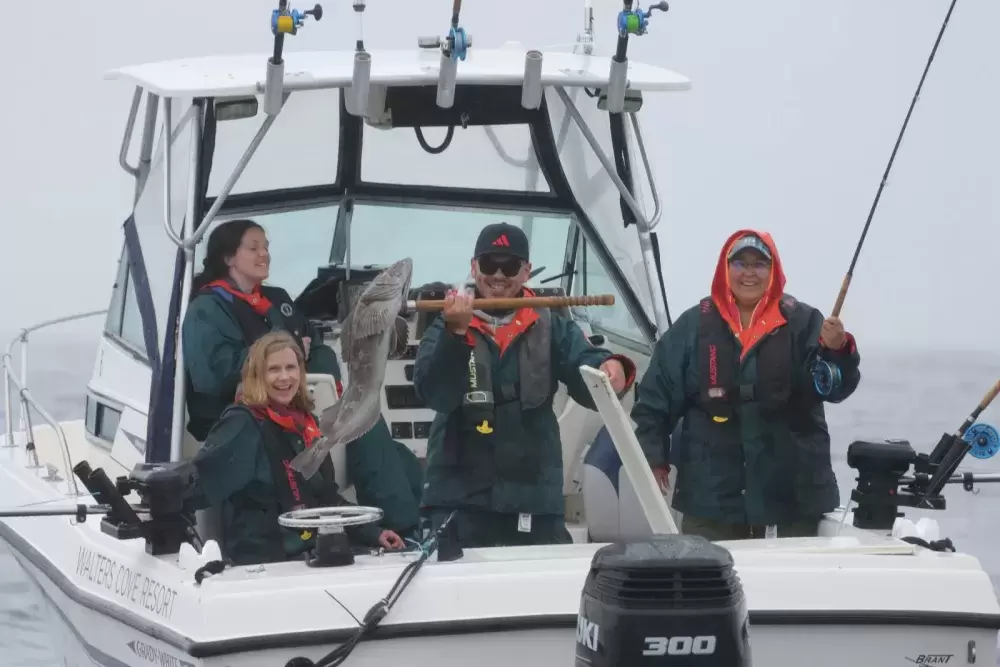 Fishing guide Darian Baker holds a fresh catch hooked by his crew on June 21 offshore from Kyuquot.