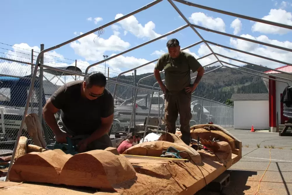 Moy Sutherland Jr. (left) and Guy Louie Jr. rework a totem pole at Port Alberni's waterfront.