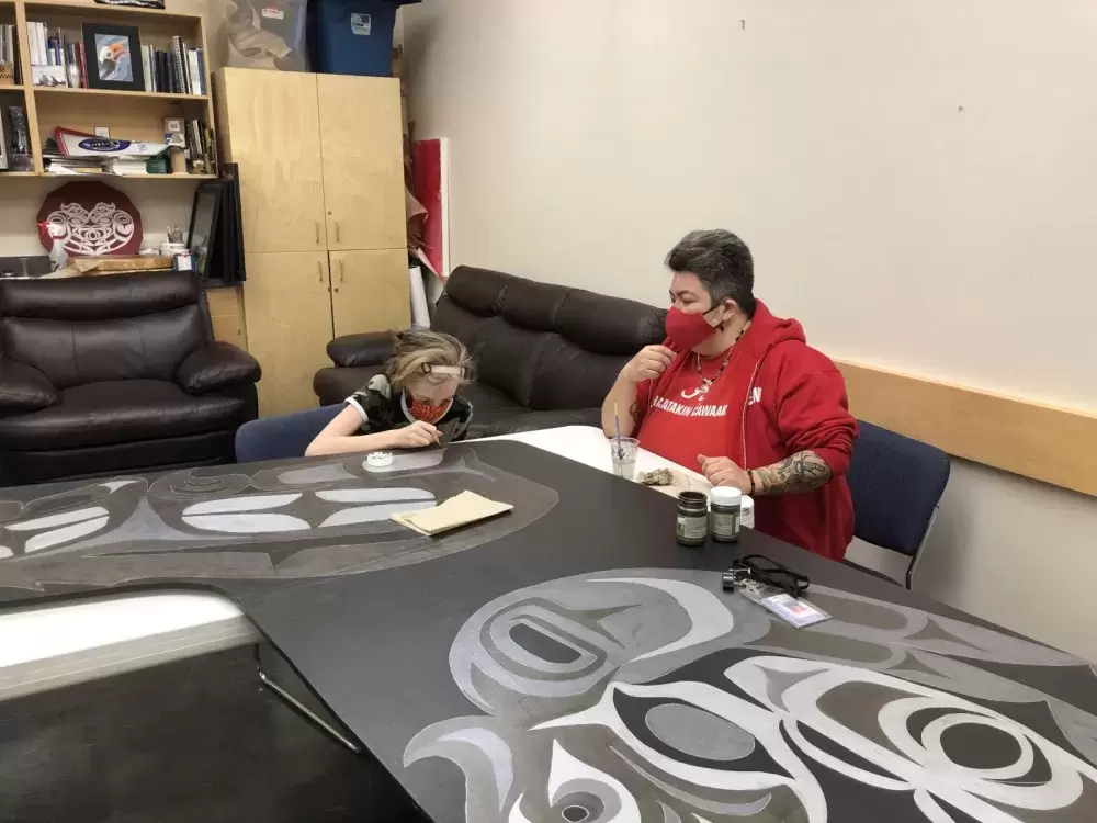 Geena Haiyupis guides student, Victoria, while she works on the 2-D canoe at ADSS. (Photo supplied by Geena Haiyupis)