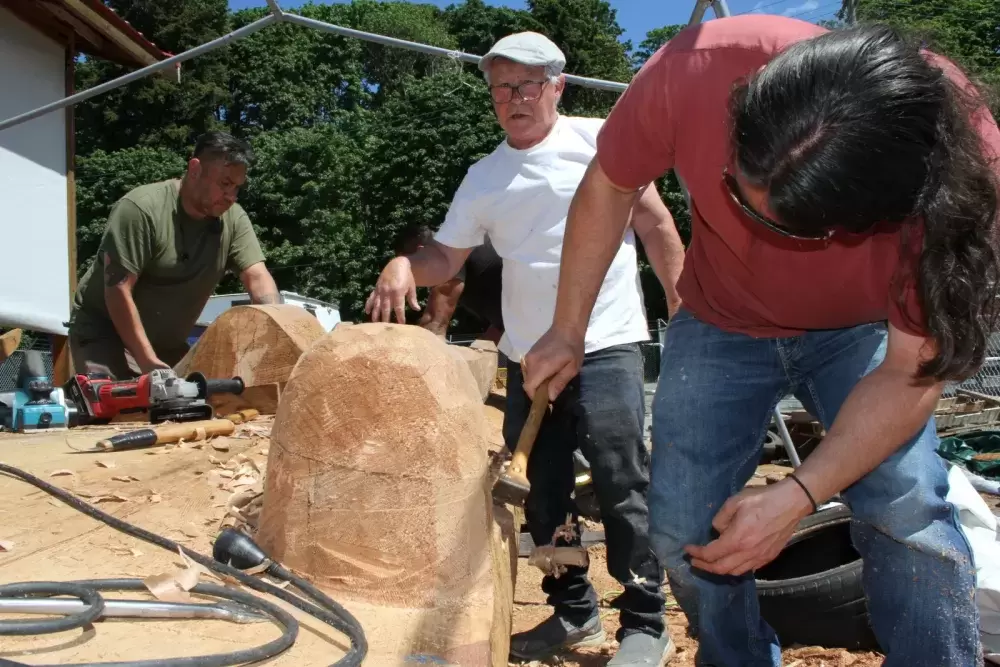 Josh Prescott (left), Peter Grant and Moy Sutherland Jr. rework a totem pole at Port Alberni's waterfront.