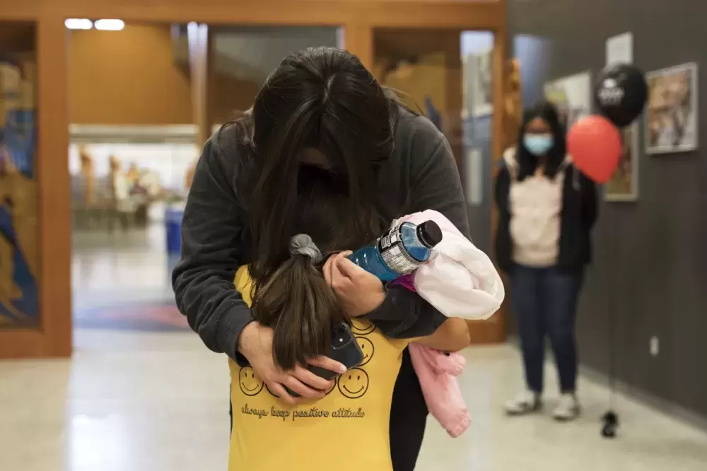 Tracy Frank hugs her daughter, Jade Thomas, after receiving a scholarship during the Nuu-chah-nulth Tribal Council Scholarship Ceremony held at the Alberni District Secondary School in Port Alberni, on June 10, 2022.