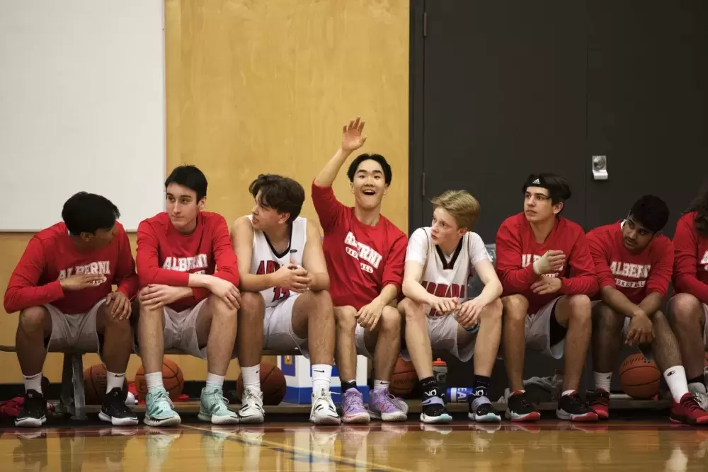 A player on the Alberni District Secondary School Armada senior boys' basketball team waves to the crowd on first night of the 66th annual Totem Tournament, at ADSS in Port Alberni, on March 10, 2022.