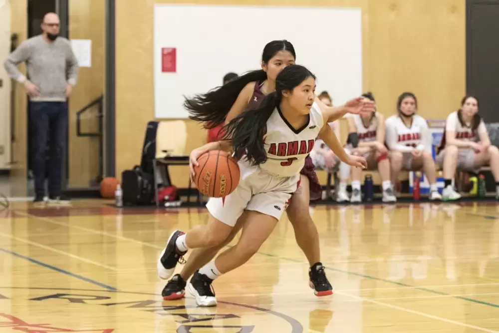 Alberni District Secondary School Armada senior girls' basketball player Brandi Lucas makes a play against her opponent on the Kwalikum Kondors senior girls' high school basketball team at the 66th annual Totem Tournament, in Port Alberni, on March 10, 2022.