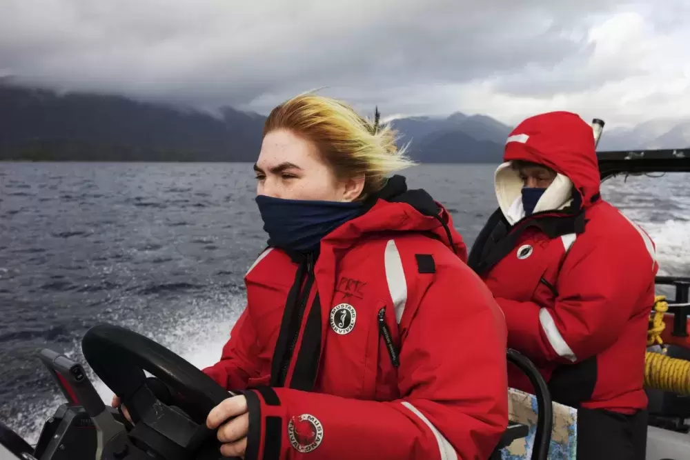 Brianna Lambert drives the boat back to Tofino while Joe Titian navigates during the Captain's Boat Camp, on Feb. 22 2021. 