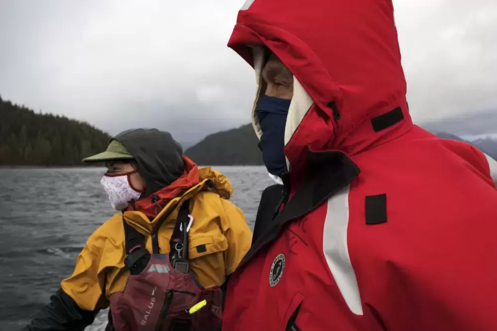 Datum Marine instructor, Marla Barker (left) and Joe Titian face the wind while driving back to Tofino during the Captain's Boat Camp, on Feb. 22 2021. Photograph by Melissa Renwick