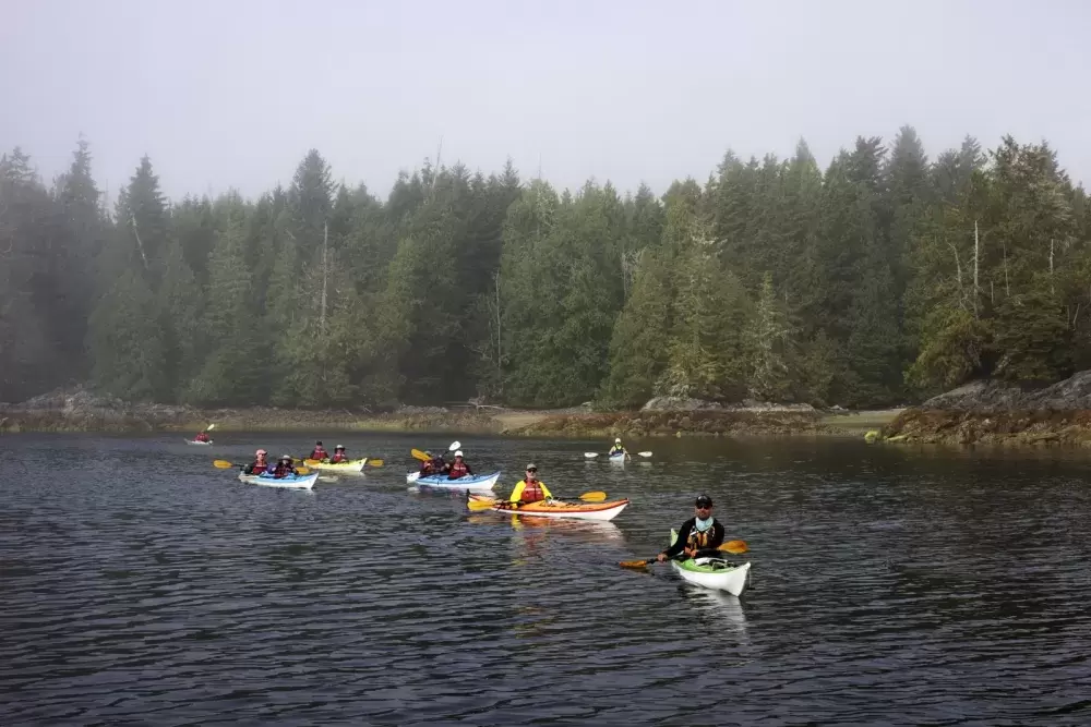 The Tseshaht Beach Keepers ask a group of kayakers what their next stop is as they depart from Hand Island, in the Broken Group Islands.