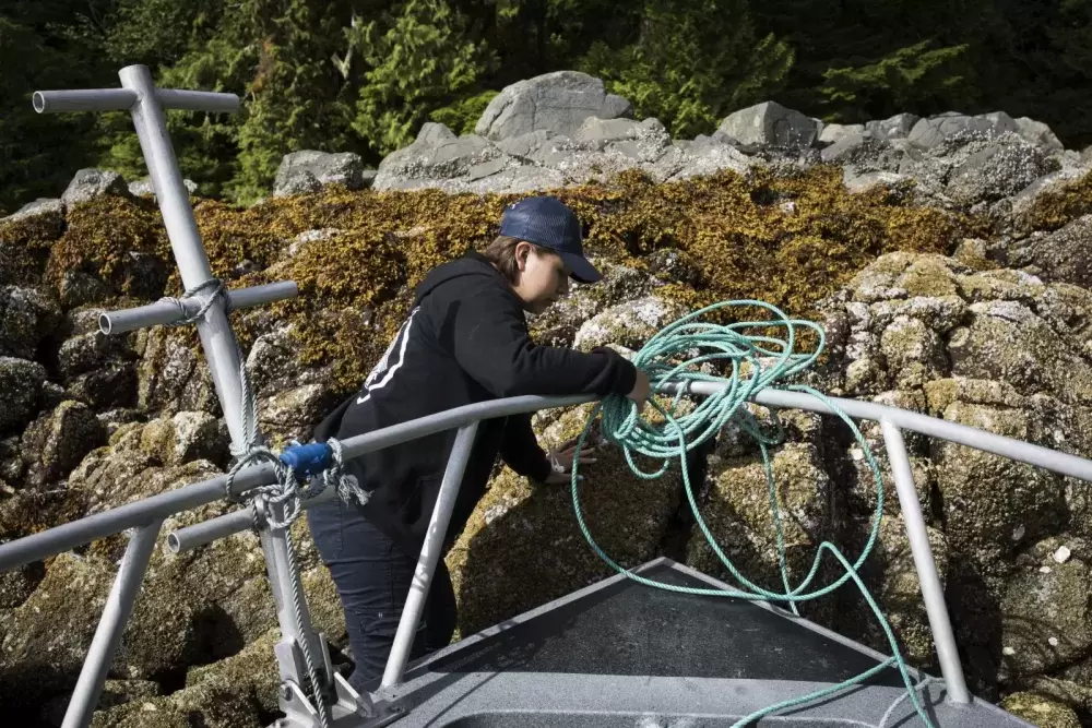 Memphis Dick secures the Tseshaht Beach Keeper boat in place on Hand Island, in the Broken Group Islands.