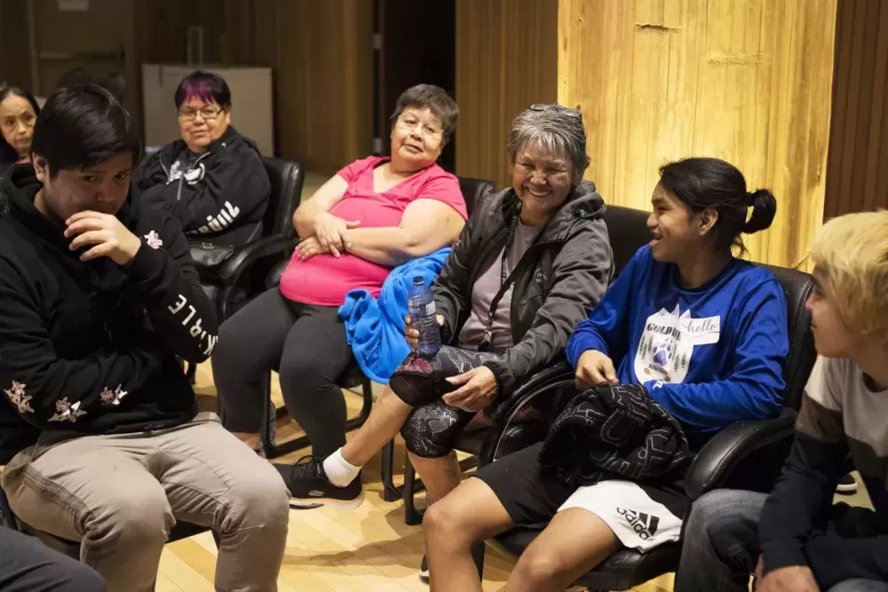 Brenda Johnson (centre) laughs with the youth at the NTC Northern Region Youth Gathering inside the House of Unity, in Tsa'xana, near Gold River, on March 29, 2022.