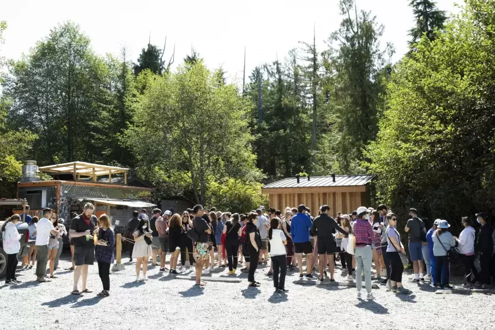 A line-up gathers outside Tacofino food truck at lunchtime, in Tofino, on August 24.