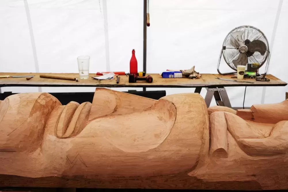 Various carvers from around the region of Tofino are helping Joe Martin carve a totem pole for his brother, Nookmis, who is the head of his family's house of Ewos. The totem pole will eventually be raised in Opitsaht, on June 7, 2021.