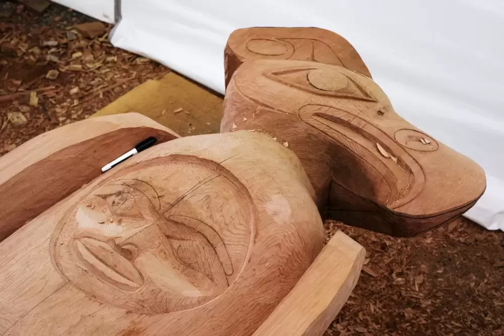 A thunderbird with the crest of a moon is carved at the top of the totem pole, in Tofino, on July 7, 2021.