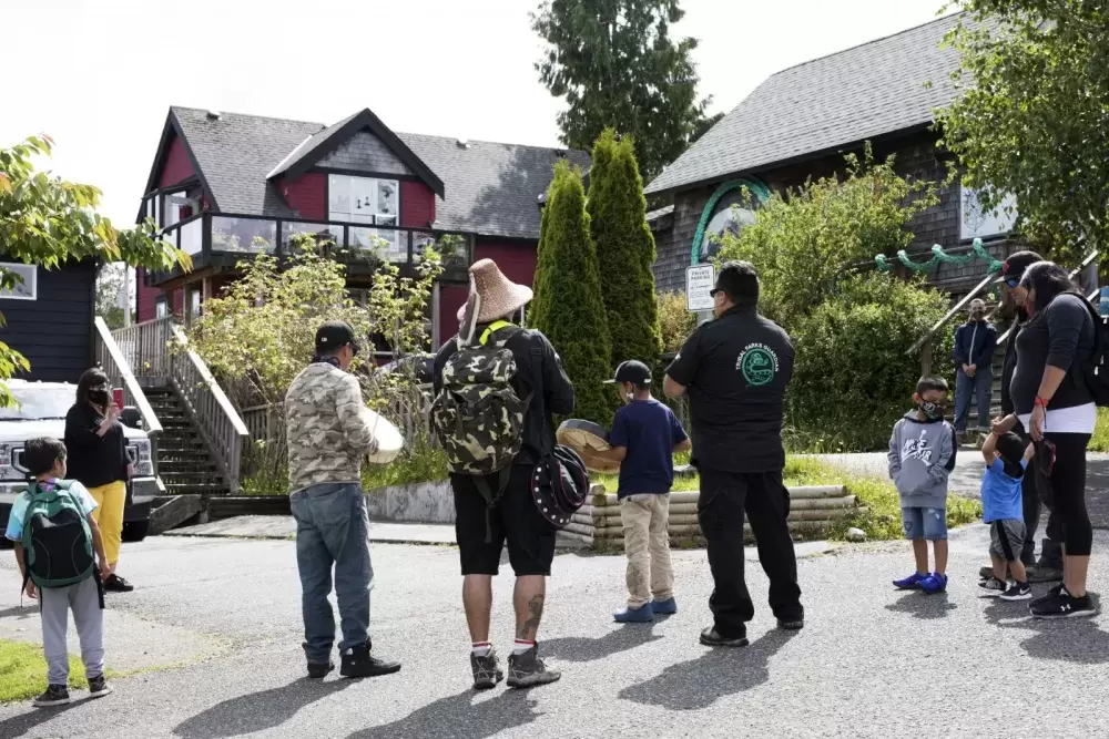 Tla-o-qui-aht Tribal Parks guardians joined to sing and drum in front of business storefronts in Tofino as a thanks for becoming a Tribal Parks ally, on June 9, 2021.