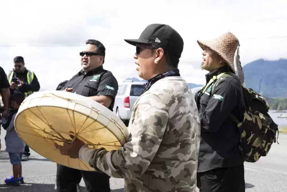 Tla-o-qui-aht Tribal Parks guardians joined to sing and drum in front of business storefronts in Tofino as a thanks for becoming a Tribal Parks ally, on June 9, 2021.