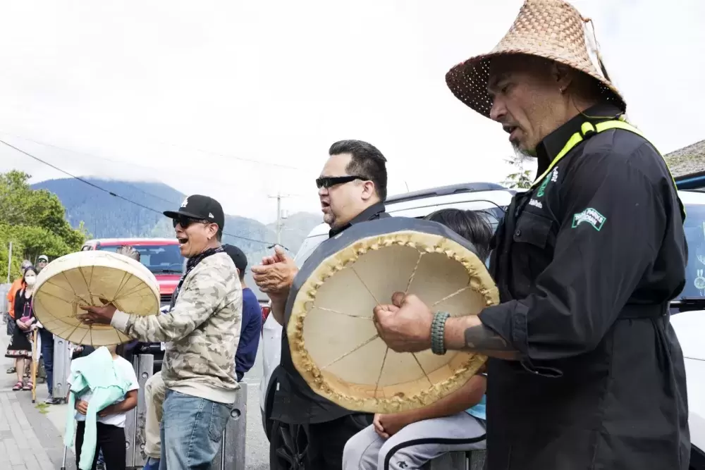 Tla-o-qui-aht Tribal Parks guardians joined to sing and drum in front of business storefronts in Tofino as a thanks for becoming a Tribal Parks ally, on June 9, 2021.