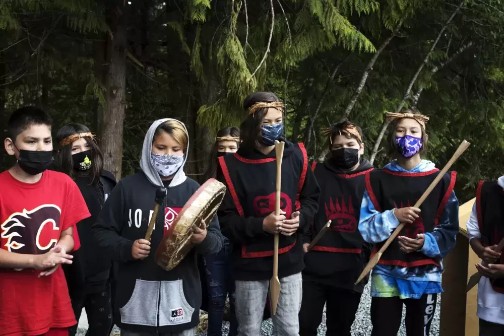 Grade 5/6 students at Haahuupayak Elementary School sing a war song during the blessing of the school's new outdoor learning space, in Port Alberni, on June 10, 2021.