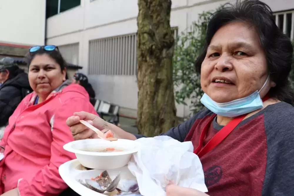 Marilyn Jones of Pacheedaht (right) enjoys the meal with her daughter Kathryn.