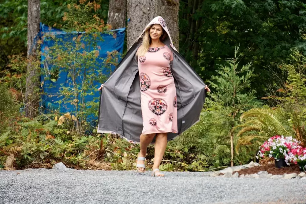 A model showcases an outfit from Ay Lelum- The Good House of Design during a fashion show at the Chims Guest House grand opening event on Aug. 7