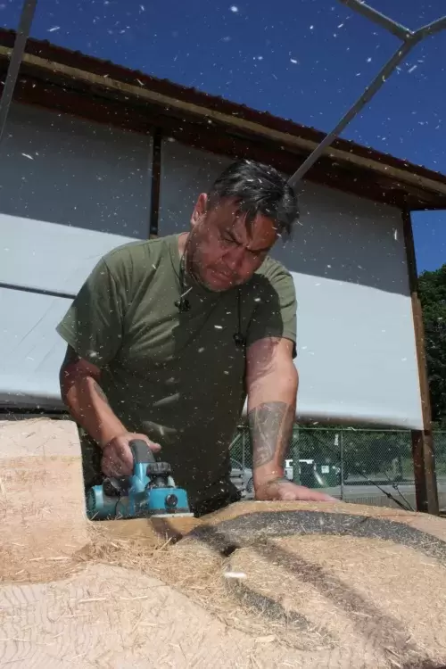 Moy Sutherland Jr. carves away at a totem pole at Port Alberni's waterfront.