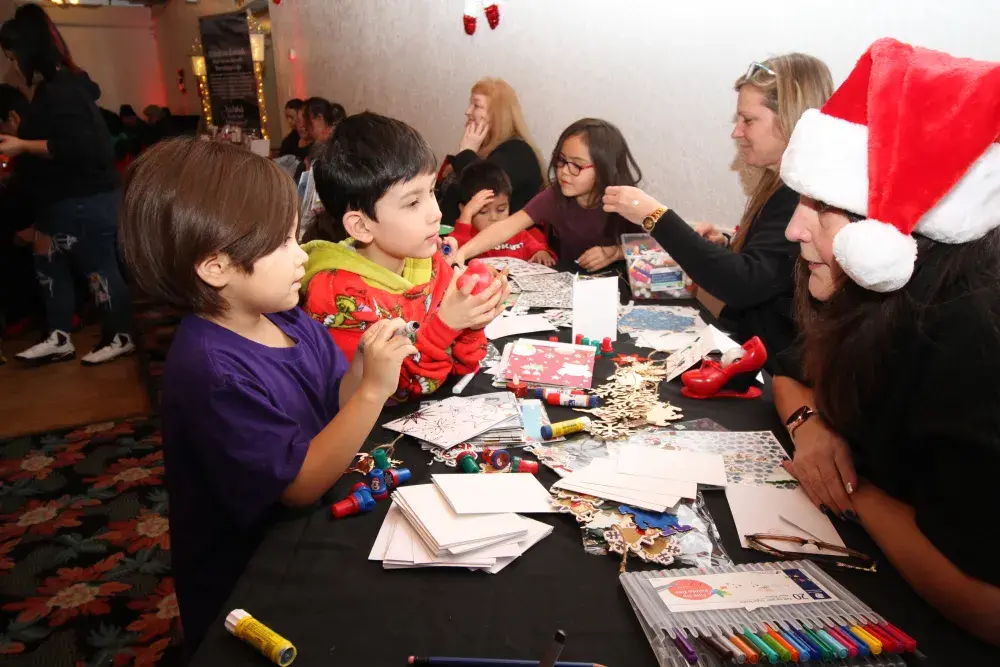 Kenna Smith speaks with Valkery Dennis about his Christmas crafts. The NTC's Child and Youth Services held a busy craft table at the Urban Gathering.