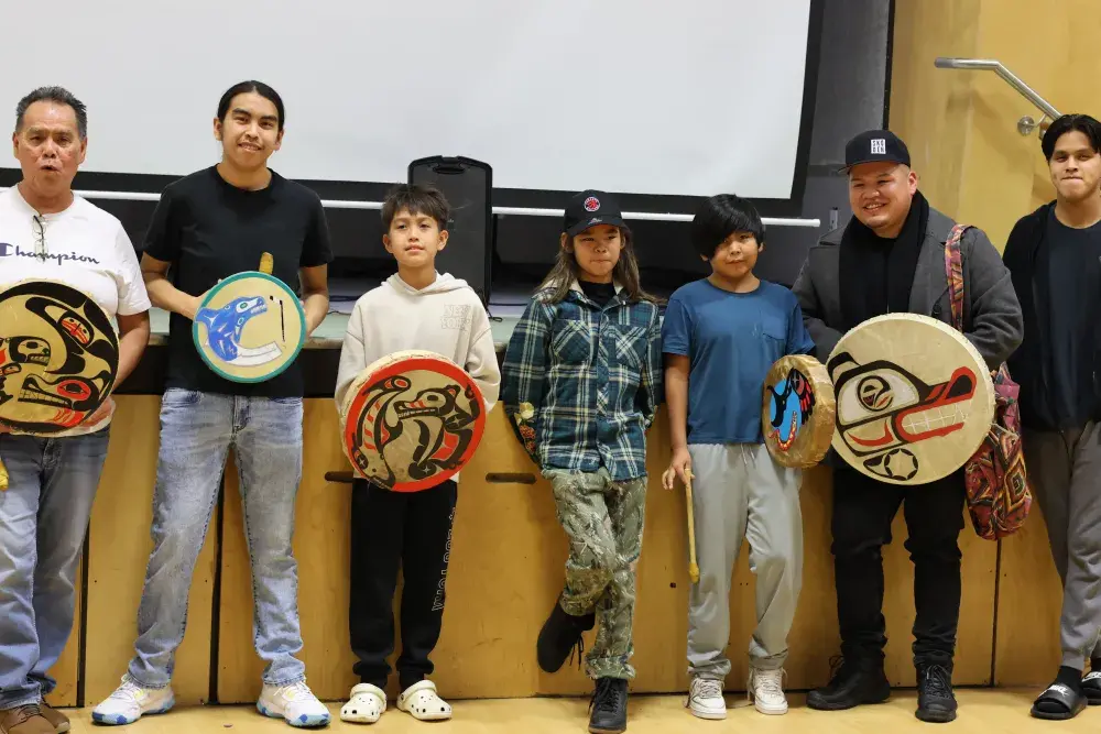 Quaya Sam, left, with a young group of traditional drummers.
