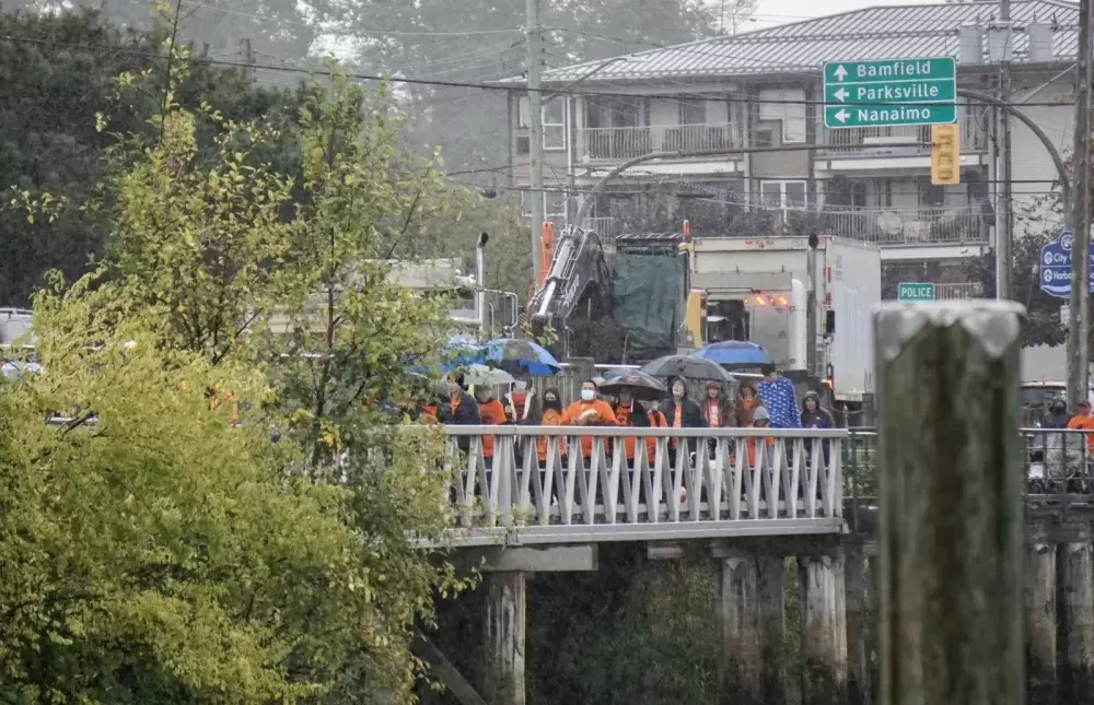 A crowd walks over the Orange Bridge to Maht Mahs gym on Sept. 30 to honour residential school survivors, and those who didn't make it home, for Orange Shirt Day and the first National Day for Truth and Reconciliation. Karly Blats photo