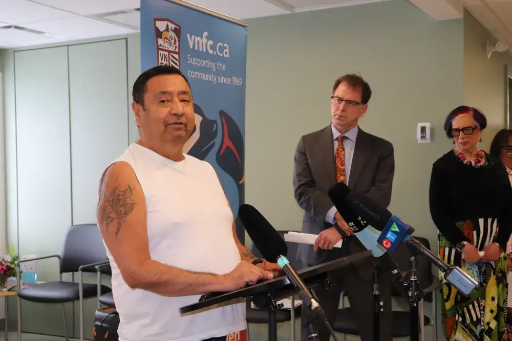 Melvin Jones speaks about his treatment at the Victoria Native Friendship Centre health facility, as Minister of Health Adrian Dix and Leah Hollins, board chair of Island Health stand listening. (Denise Titian photos) 