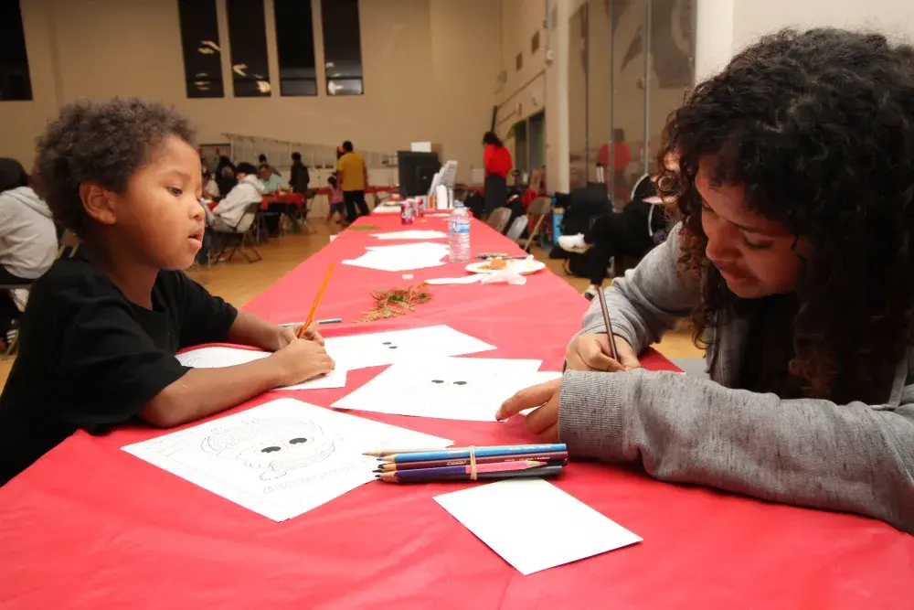 Siblings Joziah McLean (left) and Sequoia McGuire-Joseph take a break from the crowd to do some colouring.