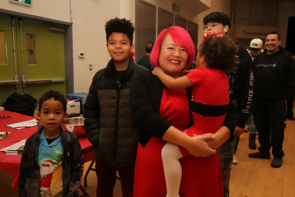 Katie Robinson waits in line for a meal with her children Koios (far left), Jamonie and Allia.