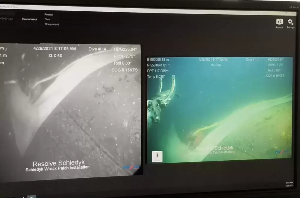 Dive platform monitors show ROV using rare-earth magnets to seal a patch on the hull of Schiedyk. (Unified Command Information Site photo)