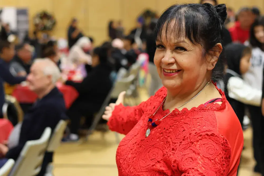 Trudy Smith welcomes people to the holiday gathering.