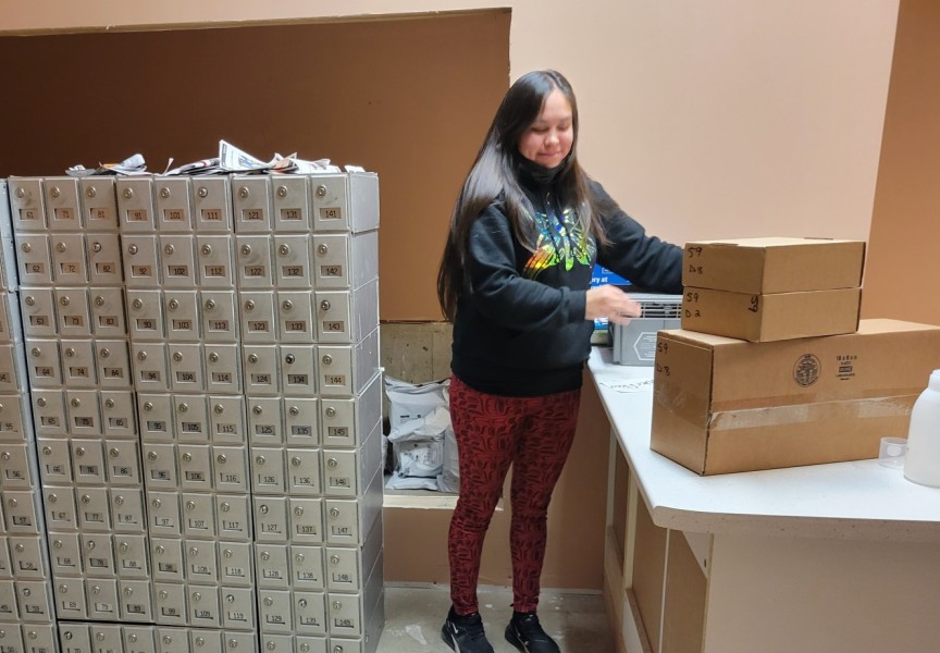 Ahousaht Postmaster Rebecca Martin prepares the post office for Ahousaht residents. (June Titian photo)