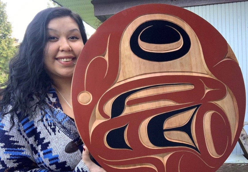 Pictured is Williams with a red cedar eagle panel carving. 