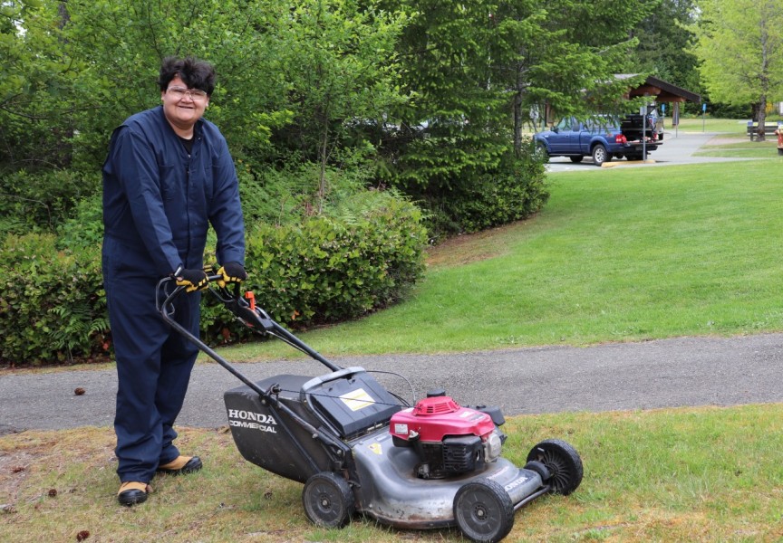 Gary Peter mows the grass at North Island College, part of his work in the Employment Transition Grounds & Custodial Assistant Program offered through the college’s Department of Accessible Learning Services (DALS). 