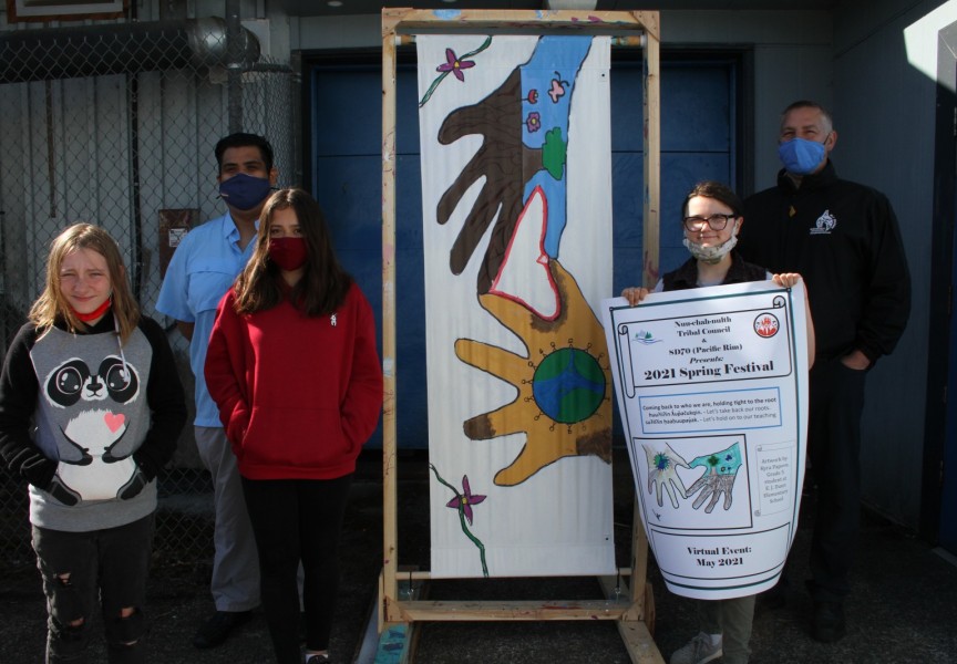 Under the concept that nature and people are one, while everyone is connected through the natural world, a poster made by Grade 5 and 6 students was chosen to promote the First Nations Spring Festival. Pictured from left to right are Azlynn Keinas, Samantha Blakey and Kyra Papove, with Richard Samuel, a cultural development supervisor with the Nuu-chah-nulth Tribal Council, and A.W. Neill Principal Darrin Olson.