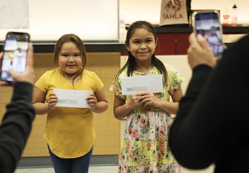 Jade Thomas (left) and Nevaeh Atleo pose with their scholarship cheques during Nuu-chah-nulth Tribal Council Scholarship Ceremony held at the Alberni District Secondary School in Port Alberni, on June 10, 2022.