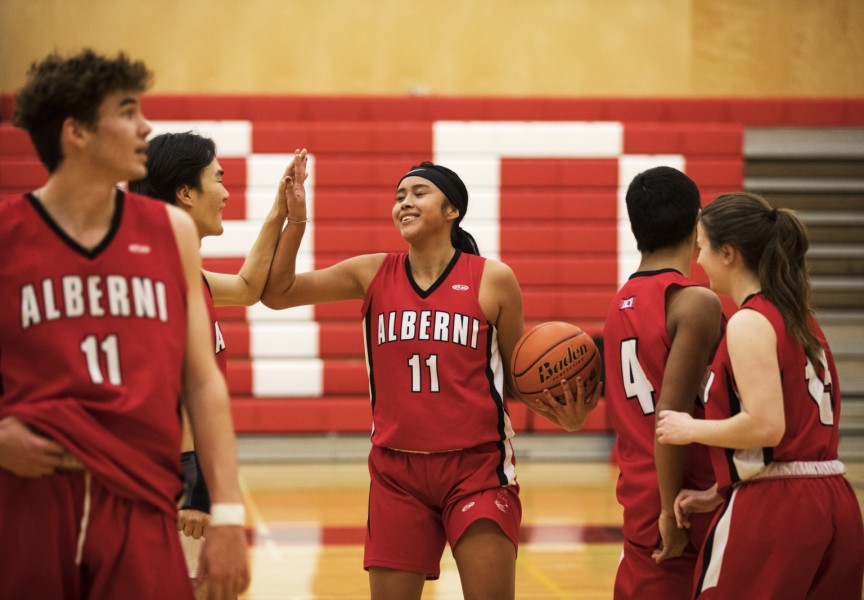 Jenelle Johnson-Sabbas high-fives a player on the Alberni District Secondary School's senior boys team after practice, in Port Alberni, on December 9, 2021.