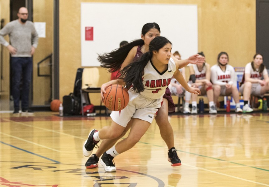 Alberni District Secondary School Armada senior girls' basketball player Brandi Lucas makes a play against her opponent on the Kwalikum Kondors senior girls' high school basketball team at the 66th annual Totem Tournament, in Port Alberni, on March 10, 2022.