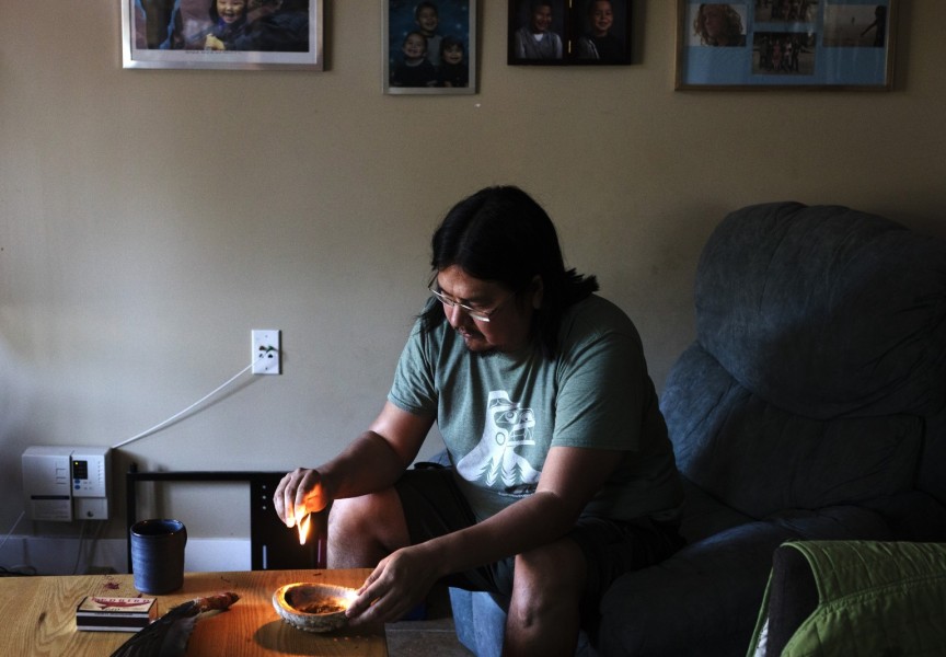 Chris Seitcher, Tla-o-qui-aht First Nation cultural support worker, cleanses himself with sage inside his home in Ty-Histanis. "Once I've created a safe space with myself, then I'm able to create a safe space in my house and I'm able to create a safe space with whoever comes into the house," said Seitcher. "When I pray and do ceremonies, I'm able to allow protection or safety or the good energy or the good spirits to come towards me."