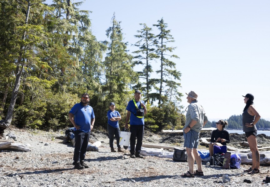 (From left to right) Shane Sieber, Memphis Dick and Hank Gus greet a group of kayakers on Gibraltar Island, in the Broken Group Islands, in Barkley Sound, on July 26, 2021.