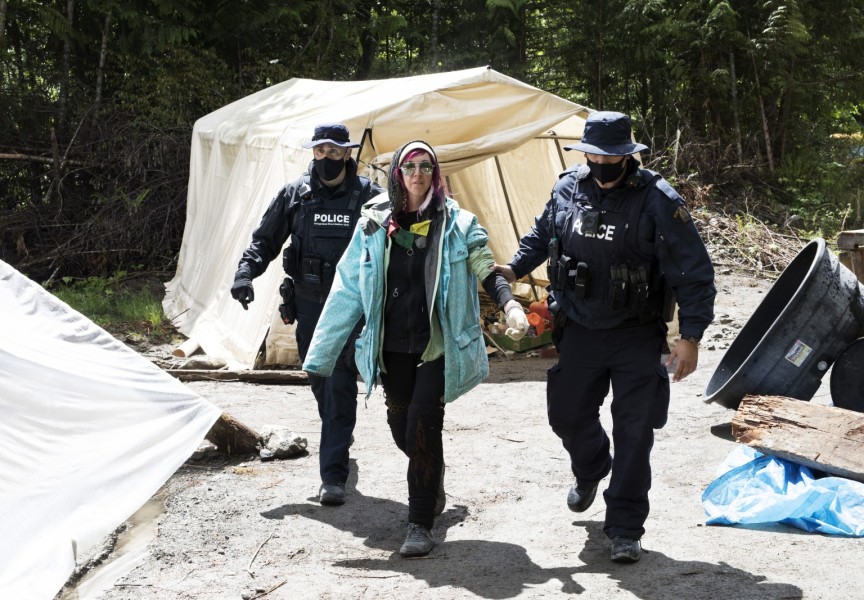 A protestor is arrested at the Caycuse old-growth logging blockade established by the Rainforest Flying Squad, near Port Renfrew, on May 19, 2021.