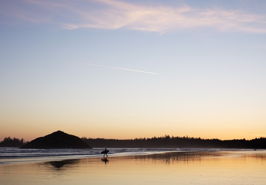 A surfer walks out of the ocean on Long Beach, near Tofino, on April 14, 2021. 