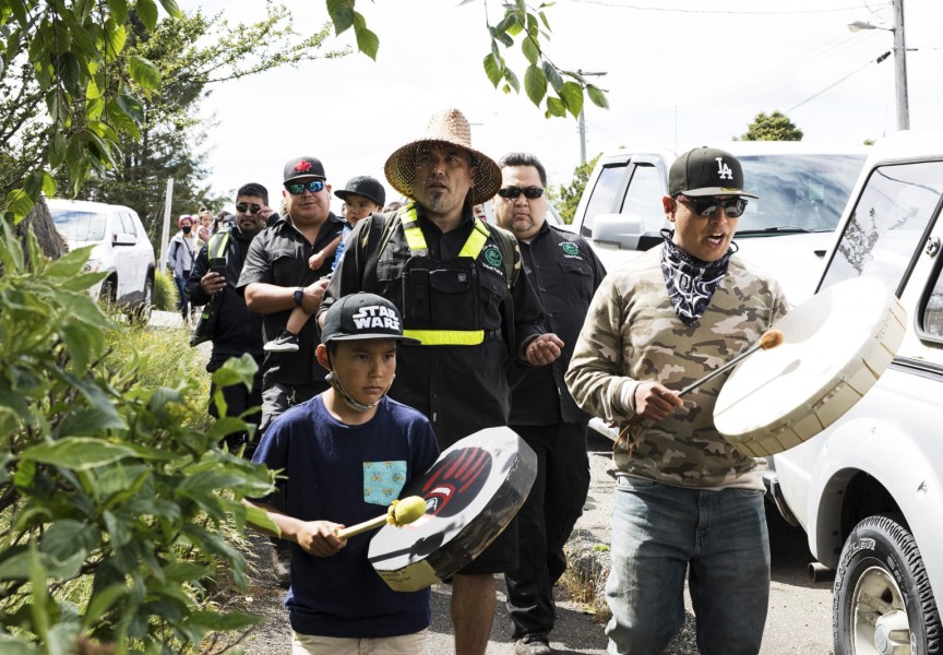 Saya Masso (centre), Tla-o-qui-aht Tribal Parks director of lands, walks along Main Street in Tofino with Tribal Parks guardians to pause in front of business storefronts to thank them for being a Tribal Parks ally, on June 9, 2021.