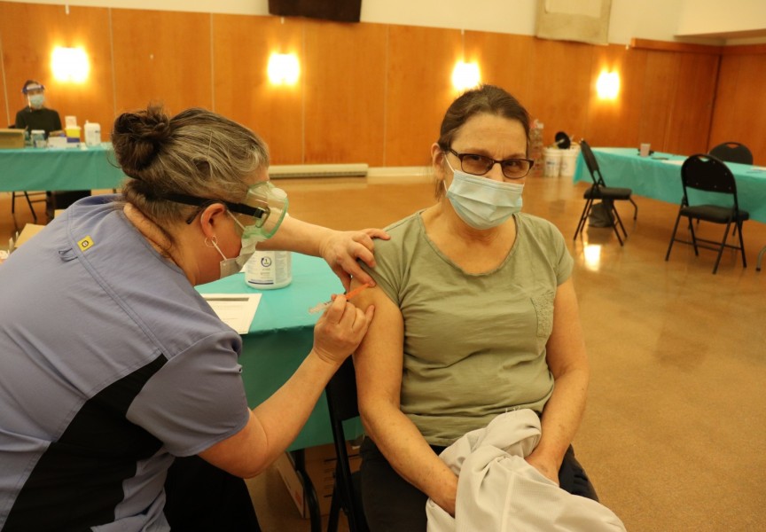 Hupacasath member Paulette Tatoosh receives her first COVID-19 shot, when NTC nurses brought Moderna doses to the House of Gathering on March 4, part of community immunization clinics being held across the province this month for on-reserve First Nations members. (Denise Titian photo) 