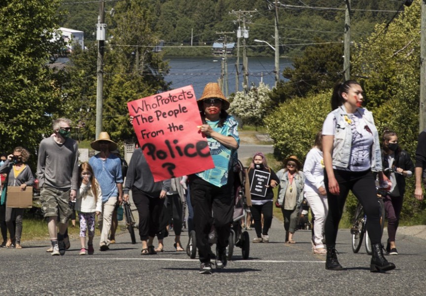 A protest marches through Ucluelet in June 2020, after Chantel Moore was fatally shot by a police officer in Edmunston, New Brunswick that spring. A new report from the BC Office of the Human Rights Commissioner is calling for funding to be redirected from police towards social services better suited to respond to mental health crises. (Melissa Renwick photo)