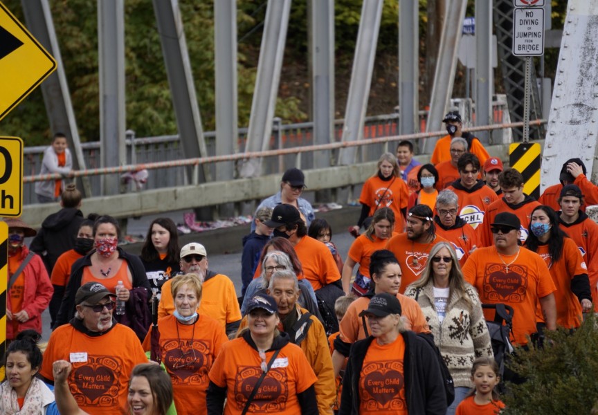 A crowd walks over the Orange Bridge to Maht Mahs gym on Sept. 30 to honour residential school survivors, and those who didn't make it home, for Orange Shirt Day and the first National Day for Truth and Reconciliation. Karly Blats photo