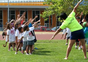 Kim Erickson helps get the group warmed up for the soft ball throw