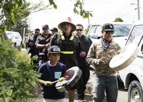 Saya Masso (centre), Tla-o-qui-aht Tribal Parks director of lands, walks along Main Street in Tofino with Tribal Parks guardians to pause in front of business storefronts to thank them for being a Tribal Parks ally, on June 9, 2021.